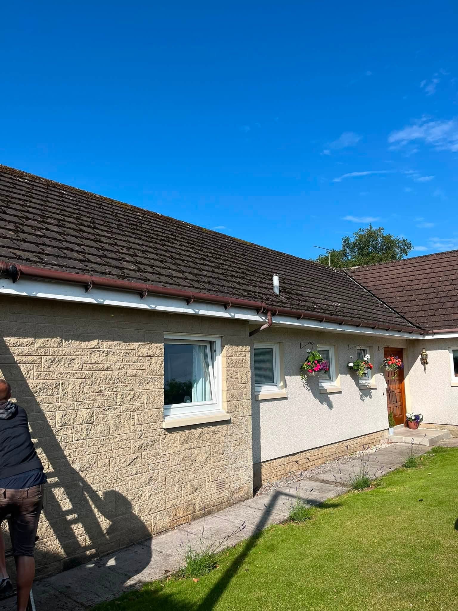 Existing fascia boards and gutter before replacement