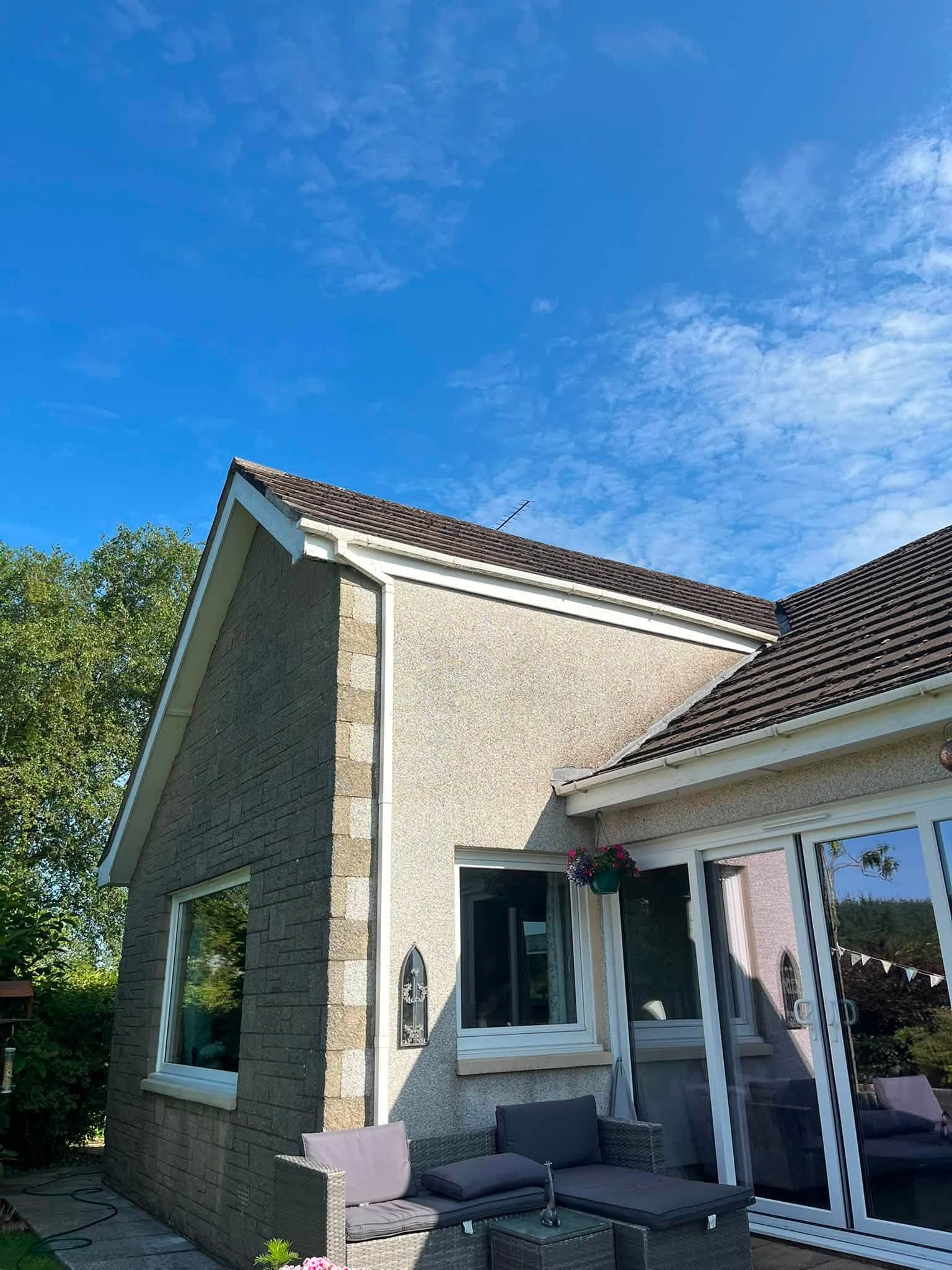 New fascia and guttering fitted around a rendered gable end