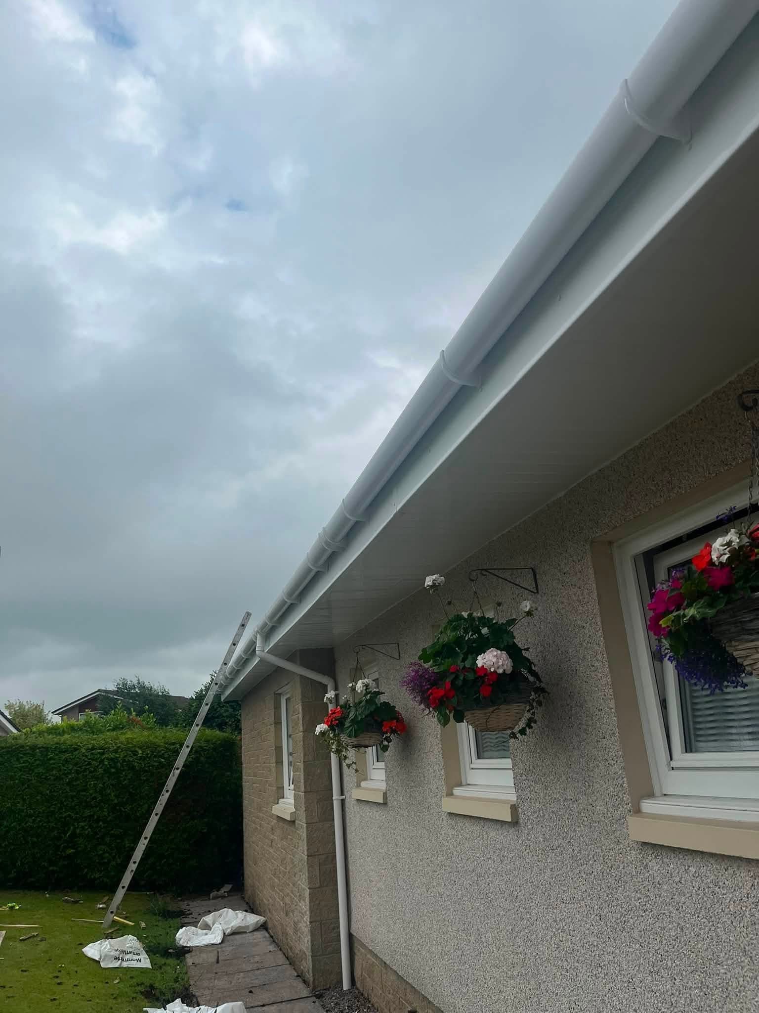 Close-up of new white fascia, soffit and round guttering under the eaves
