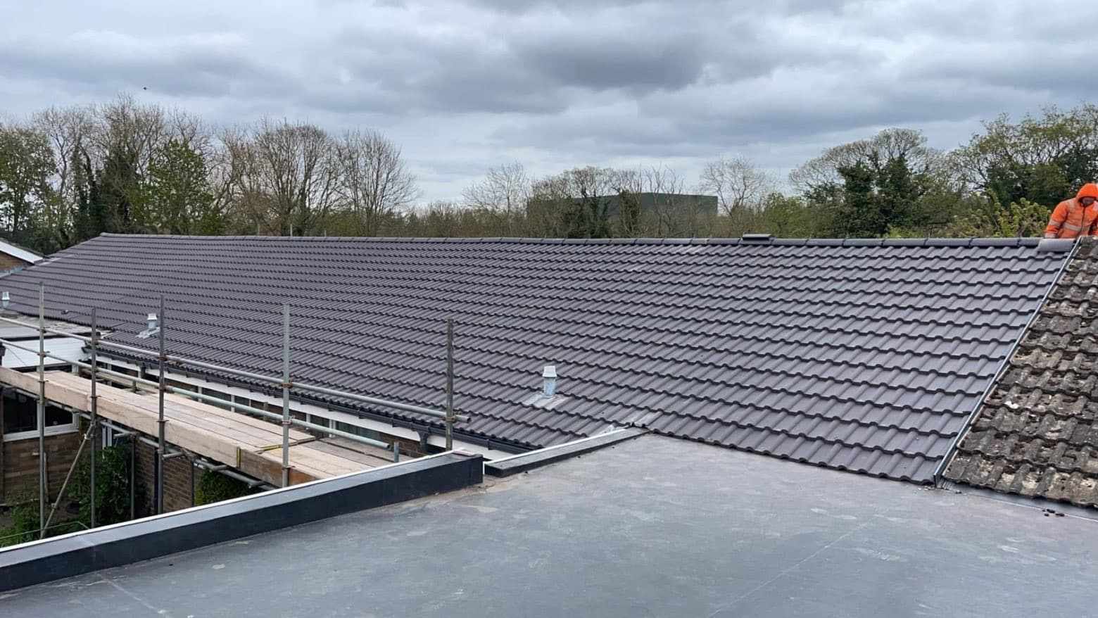 Completed tile re-roof across a residential building by RML Roofing Services