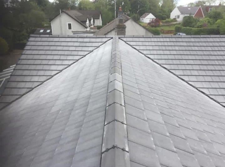 Ridge line of a newly tiled grey roof