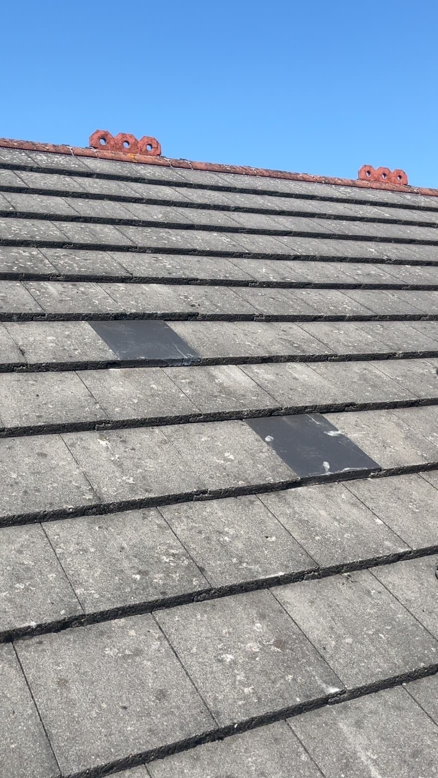 Replacement slate tiles fitted in among the existing roof slates