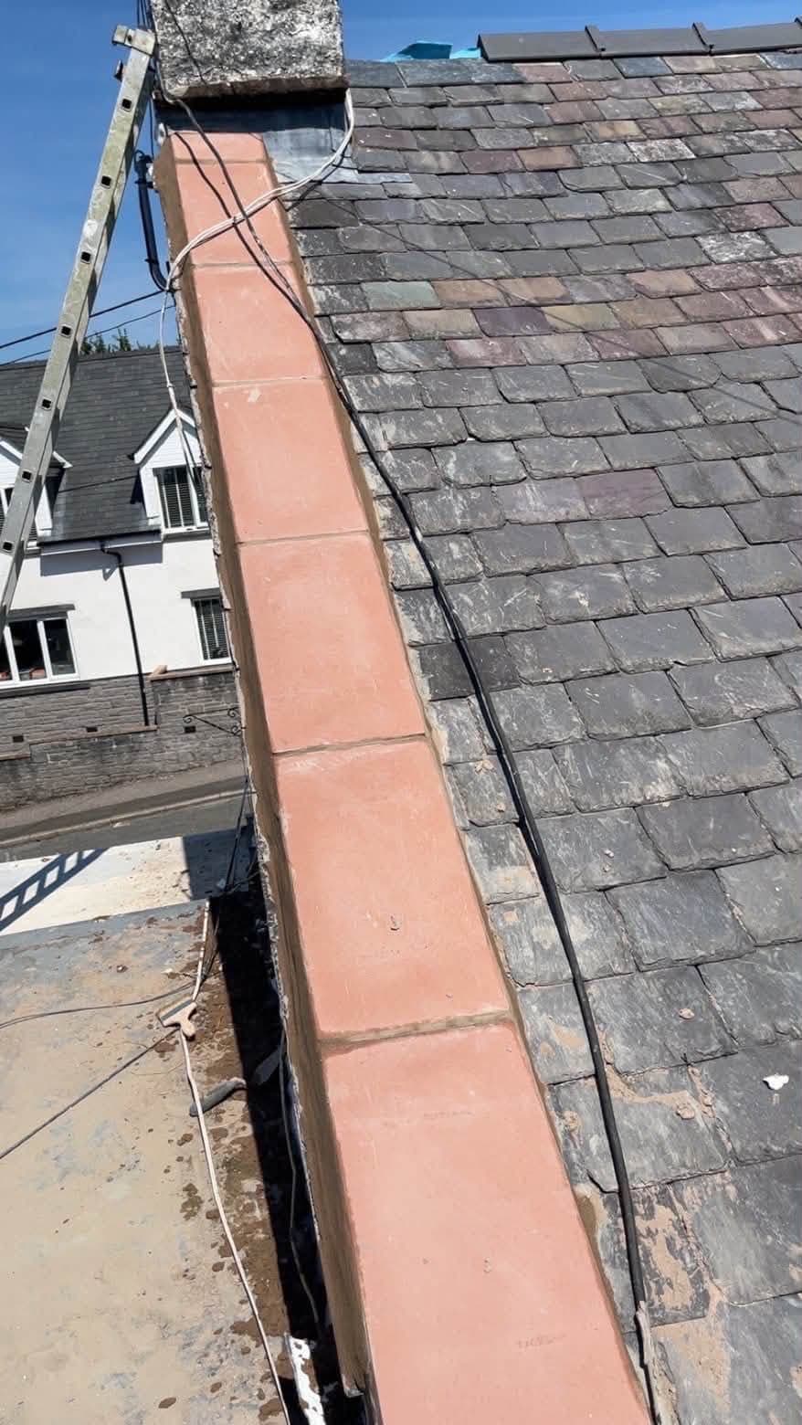 New sand-cement fillet and reinstated coping stones along the gable end
