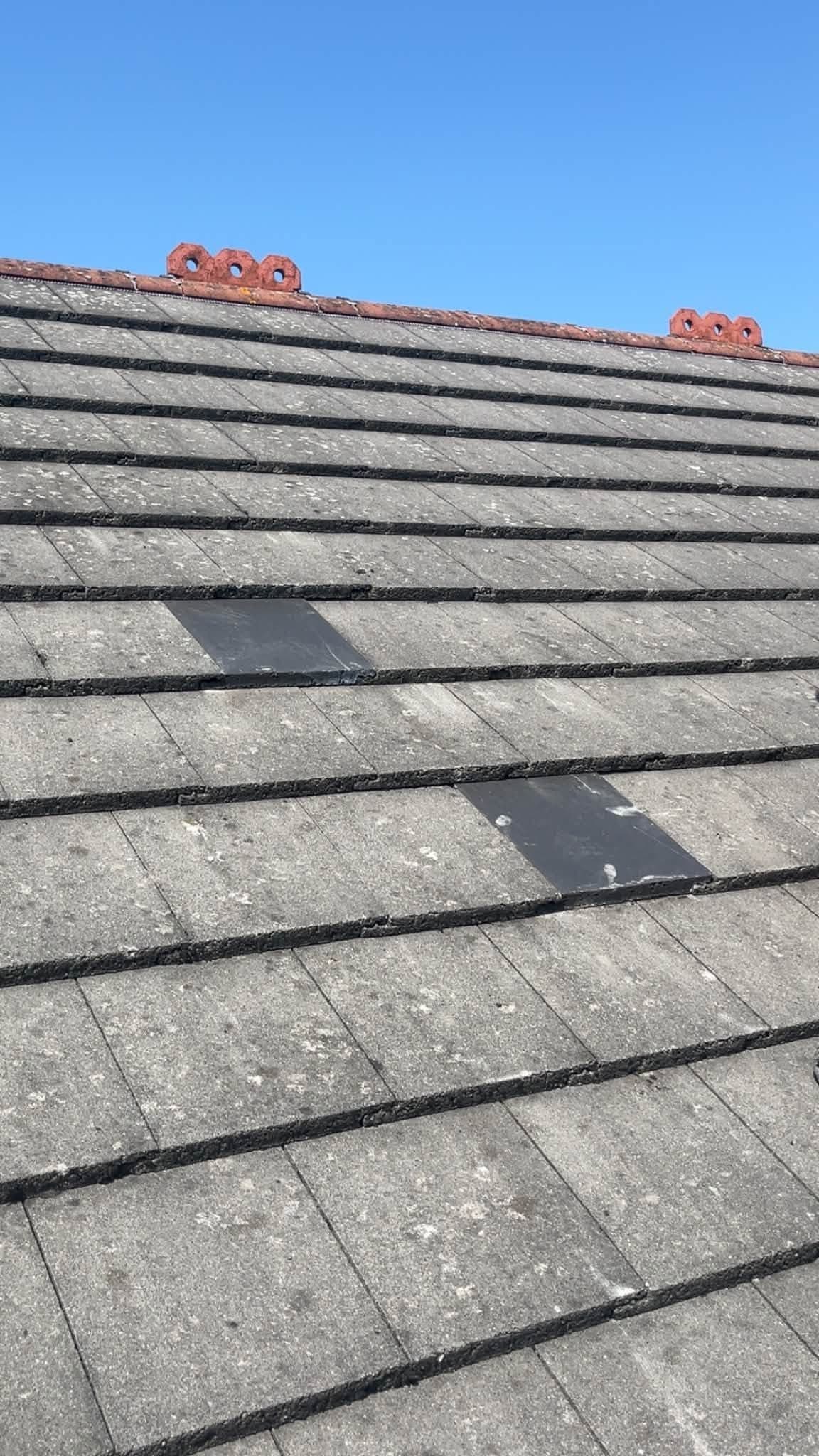 New tiles fitted in place of the cracked ones, near the ridge